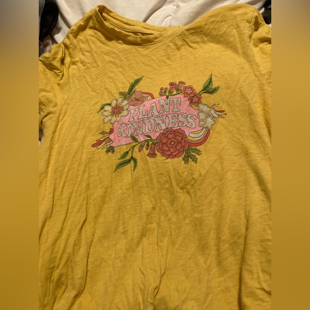 T-shirt with flowers and “Plant Kindness” design